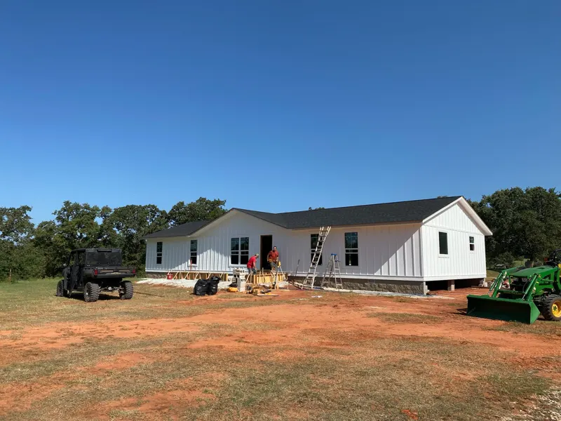 White board-and-batten home on acreage