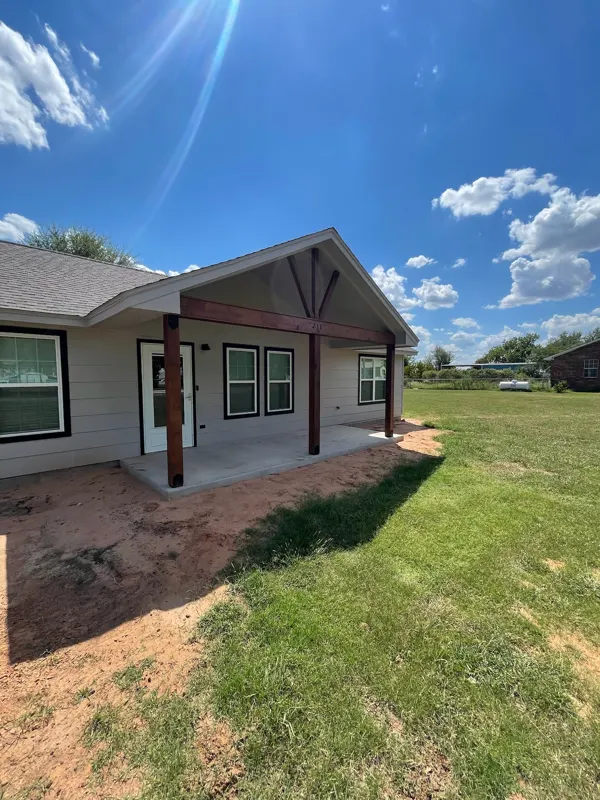 Gray-sided home with timber porch gable