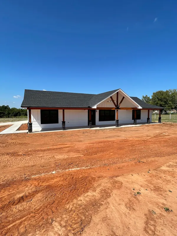 White farmhouse with timber gable over the porch
