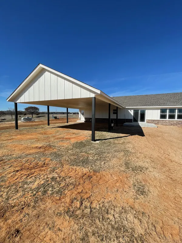 White home with a large covered carport