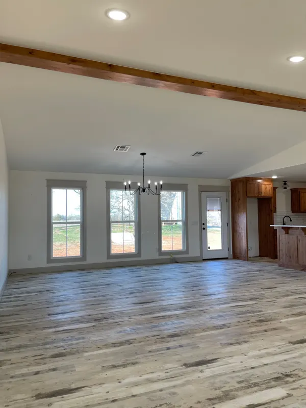 Open living room with a wood ceiling beam