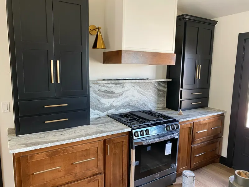 Black-cabinet kitchen with marble backsplash