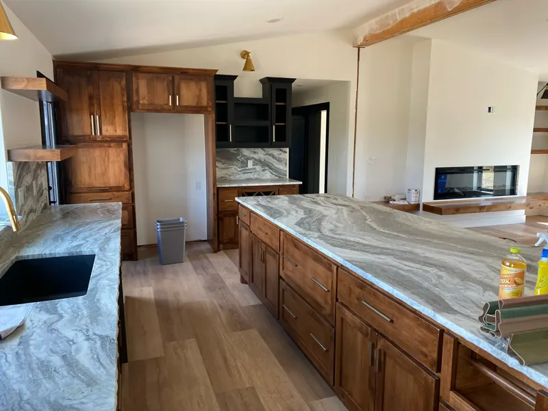 Kitchen with wood cabinets and a linear fireplace