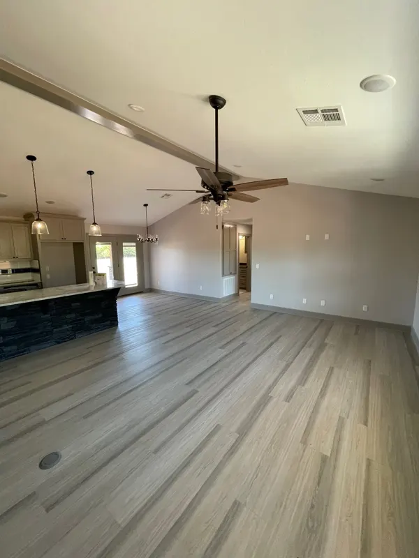 Vaulted living room with ceiling fan