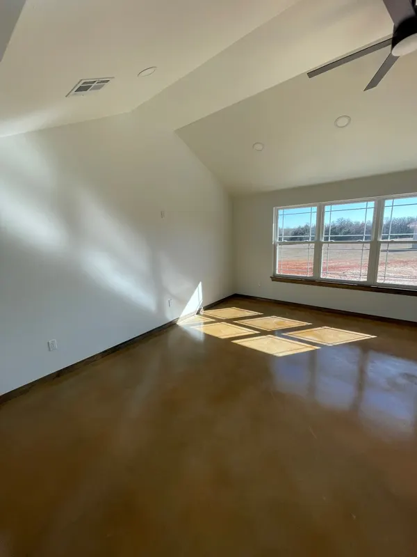Sunlit living room with stained concrete floors
