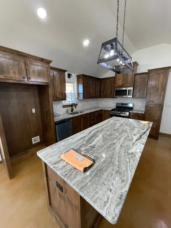 Kitchen with wood cabinets and granite island