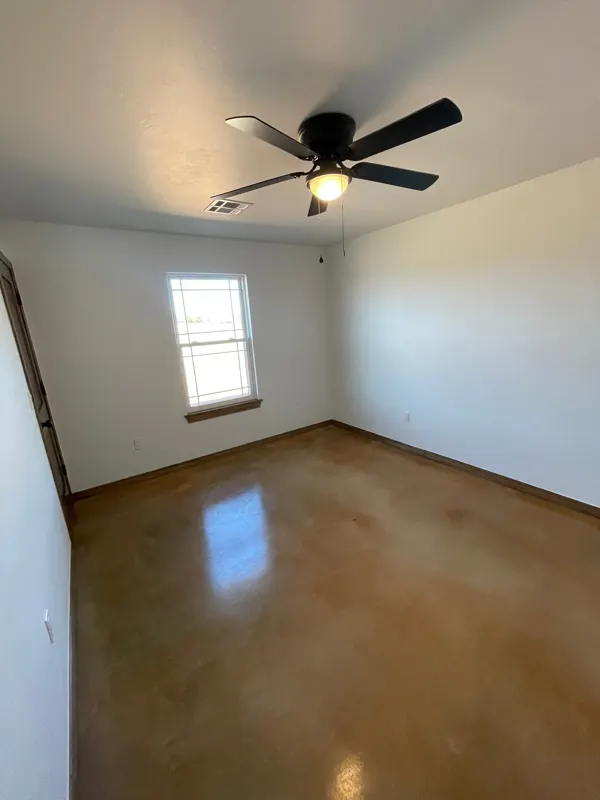 Bedroom with stained concrete floor