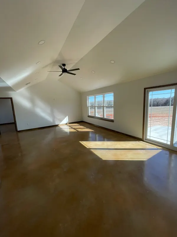 Primary bedroom with vaulted ceiling